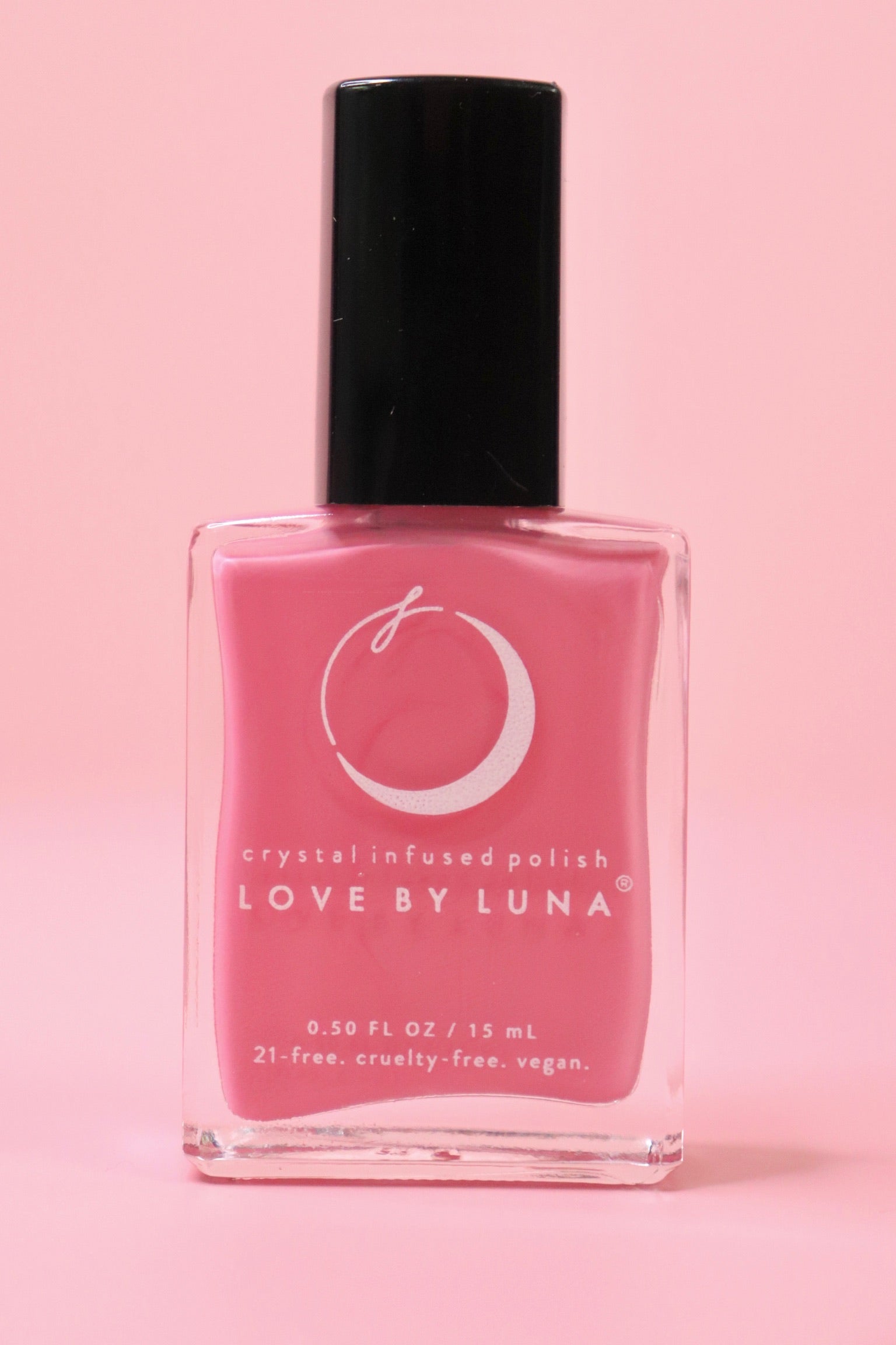The Love in Bloom Nail Polish with Micronized Rose Quartz & Pink Calcite on a pink background.