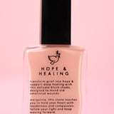 The Hope & Healing Nail Polish with Micronized Morganite on a pink background.