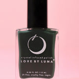 The Regeneration Nail Polish with Micronized Bloodstone on a pink background.