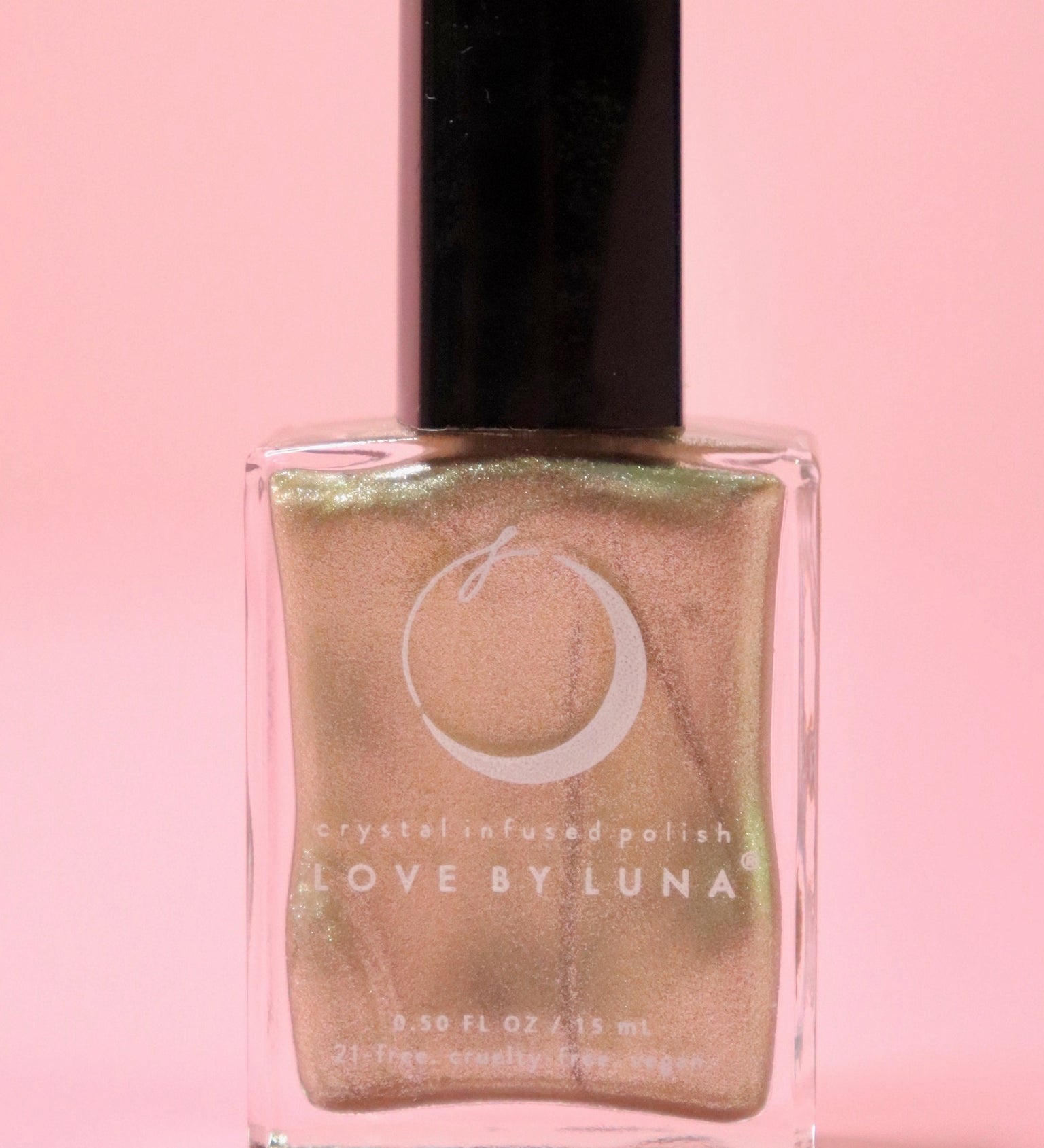 The Abundance Boost Nail Polish with Micronized Pyrite on a pink background.