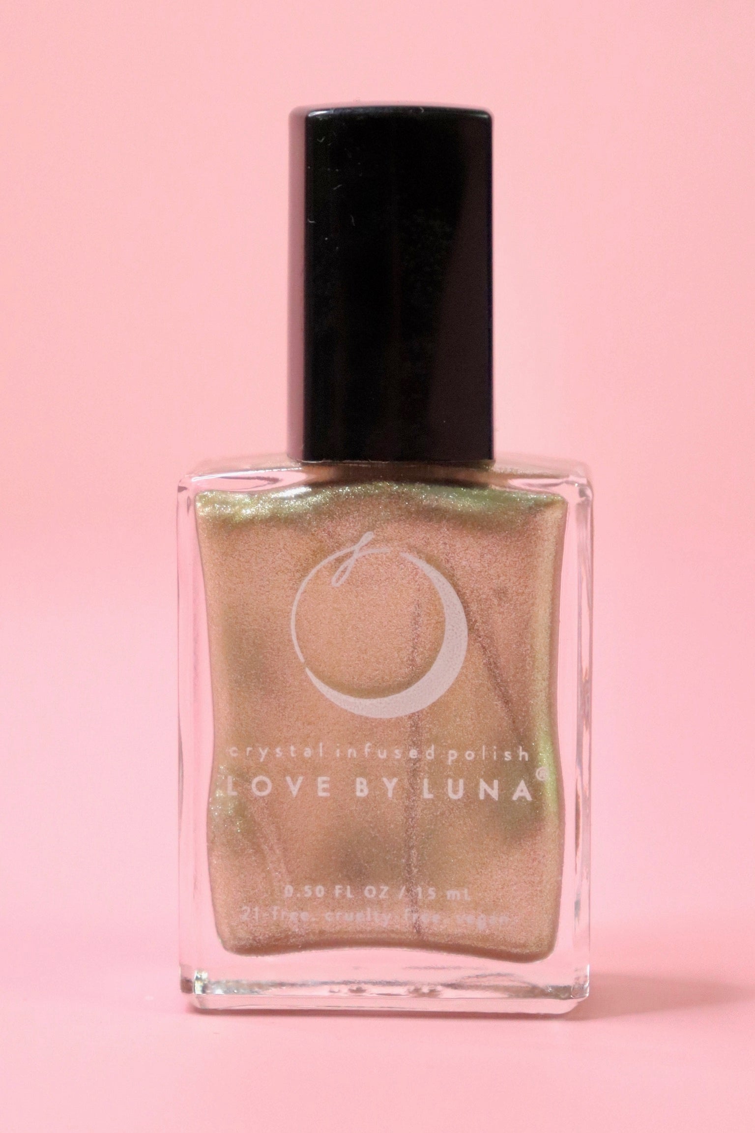 The Abundance Boost Nail Polish with Micronized Pyrite on a pink background.