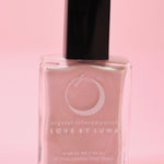 The Libra Zodiac Nail Polish with Micronized Rose Quartz in a pink background.