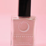 The Libra Zodiac Nail Polish with Micronized Rose Quartz in a pink background.