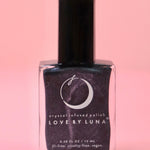 The Scorpio Zodiac Nail Polish with Micronized Obsidian on a pink background.