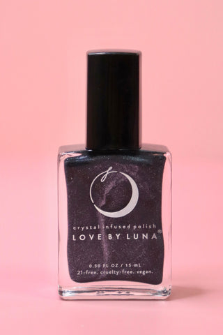 The Scorpio Zodiac Nail Polish with Micronized Obsidian on a pink background.