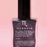 The Scorpio Zodiac Nail Polish with Micronized Obsidian on a pink background.