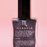 The Scorpio Zodiac Nail Polish with Micronized Obsidian on a pink background.