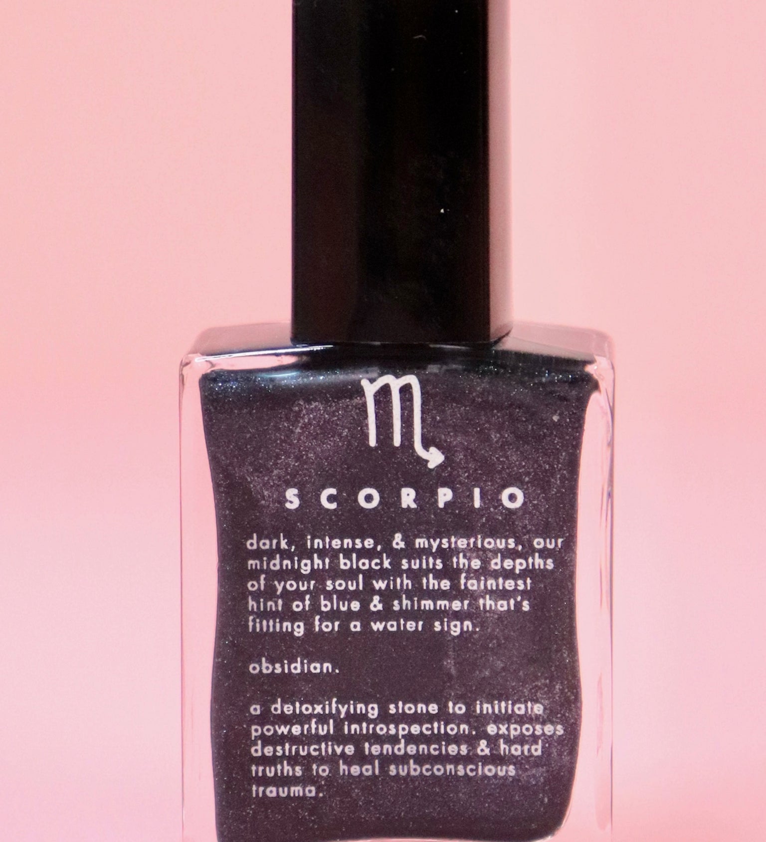 The Scorpio Zodiac Nail Polish with Micronized Obsidian on a pink background.