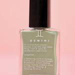  The Gemini Zodiac Nail Polish with Micronized Serpentine on a pink background.