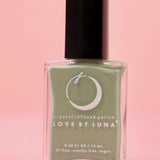  The Gemini Zodiac Nail Polish with Micronized Serpentine on a pink background.