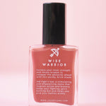 The Wise Warrior Nail Polish with Micronized Tiger's Eye on a pink background.