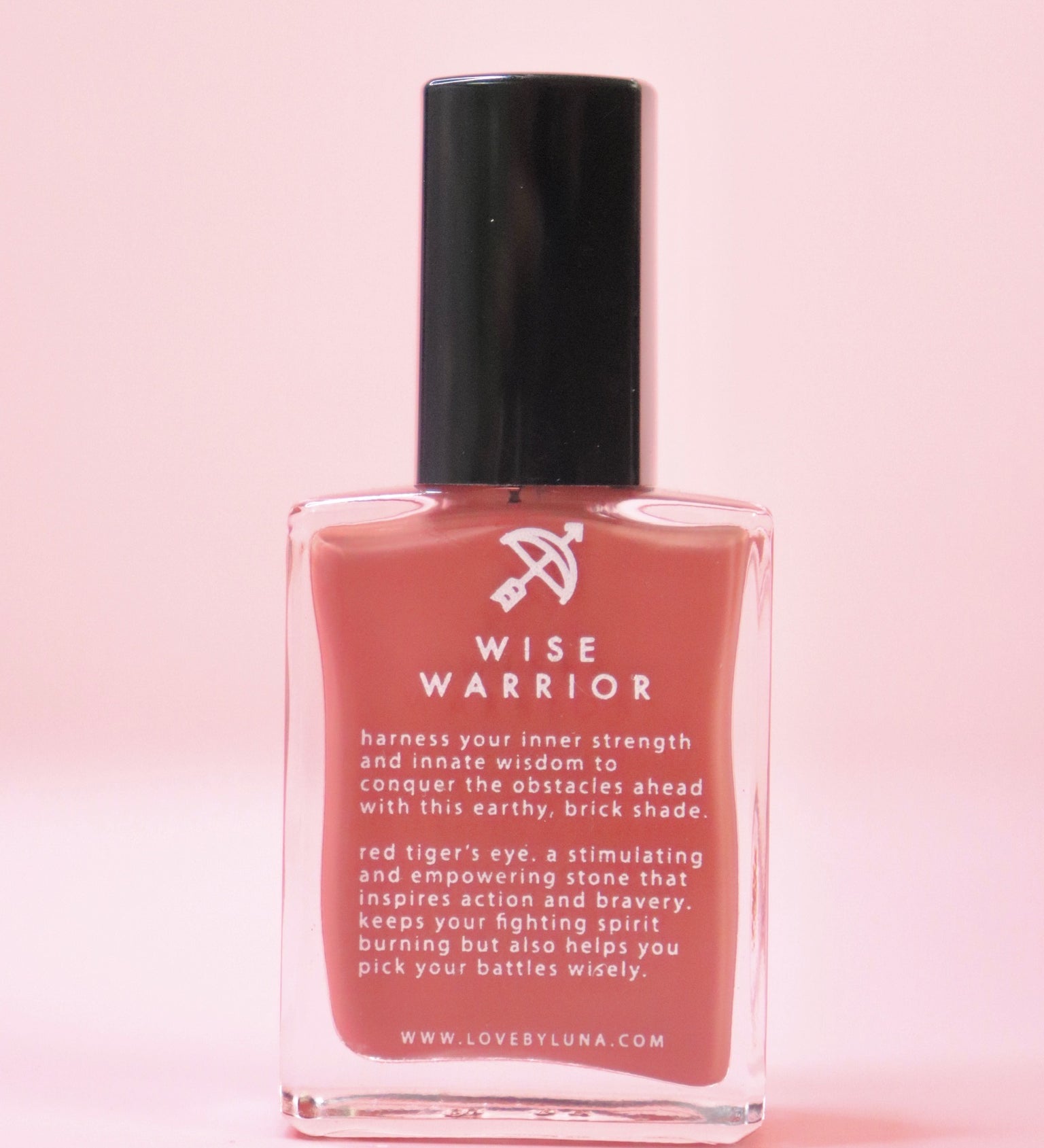 The Wise Warrior Nail Polish with Micronized Tiger's Eye on a pink background.