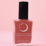 The Wise Warrior Nail Polish with Micronized Tiger's Eye on a pink background.