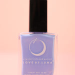 The Retrograde Rescue Nail Polish with Micronized Blue Lace Agate on a pink background.