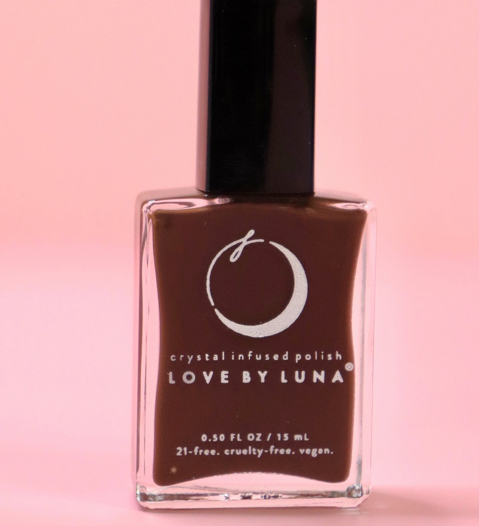 The Energy Shield Nail Polish with Micronized Smoky Quartz on a pink background.