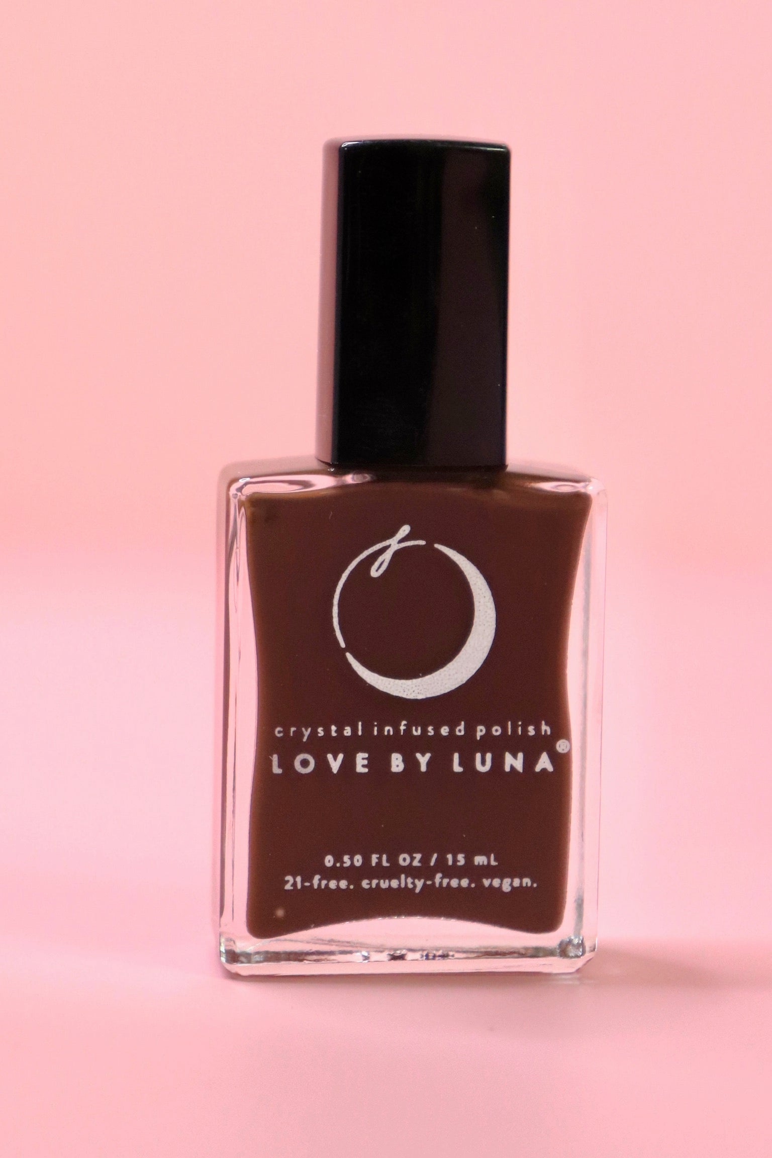 The Energy Shield Nail Polish with Micronized Smoky Quartz on a pink background.