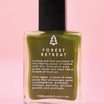 The Forest Retreat Nail Polish with Micronized Moss Agate on a pink background.
