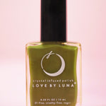 The Forest Retreat Nail Polish with Micronized Moss Agate on a pink background.