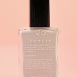 The Cancer Zodiac Nail Polish with Micronized Moonstone on a pink background.