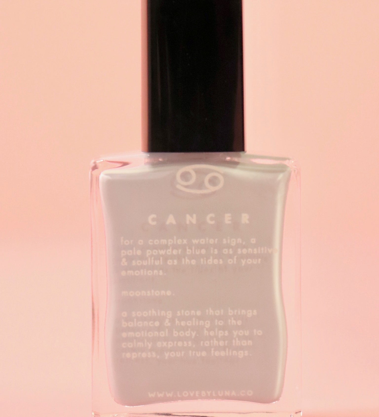 The Cancer Zodiac Nail Polish with Micronized Moonstone on a pink background.