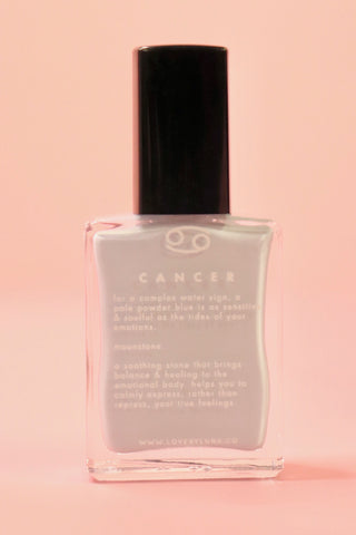 The Cancer Zodiac Nail Polish with Micronized Moonstone on a pink background.