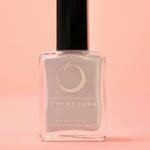The Cancer Zodiac Nail Polish with Micronized Moonstone on a pink background.