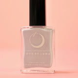 The Cancer Zodiac Nail Polish with Micronized Moonstone on a pink background.
