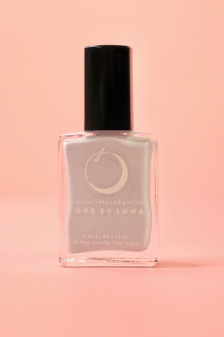 The Cancer Zodiac Nail Polish with Micronized Moonstone on a pink background.