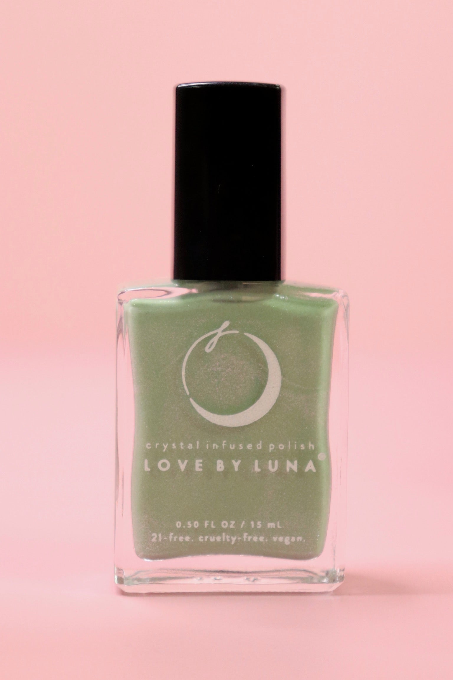 The Manifestation Magic Nail Polish with Micronized Green Aventurine on a pink background.