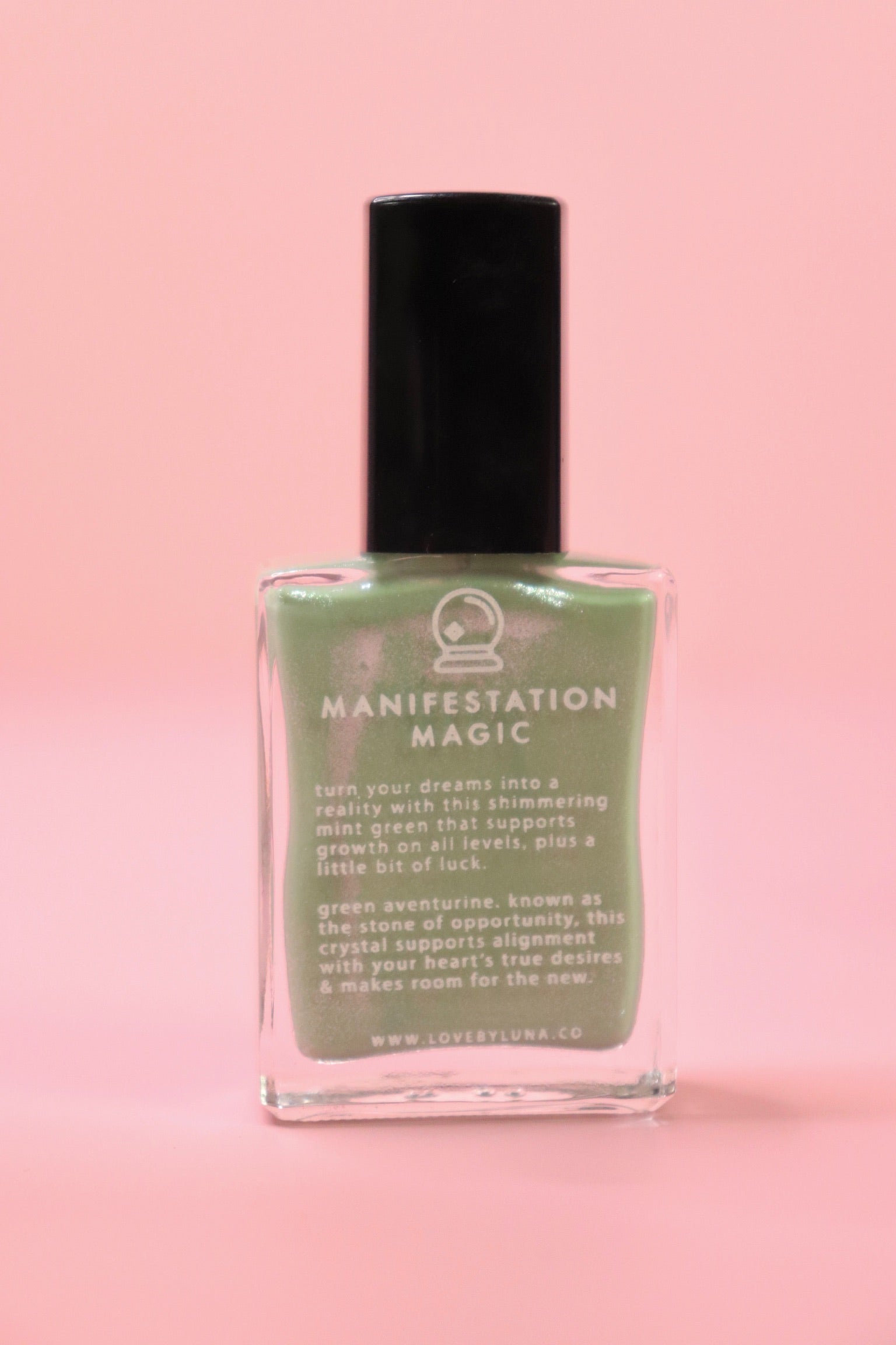 The Manifestation Magic Nail Polish with Micronized Green Aventurine on a pink background.