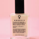 The Goddess Nail Polish with Micronized Rose Quartz, Selenite, & Moonstone on a pink background.