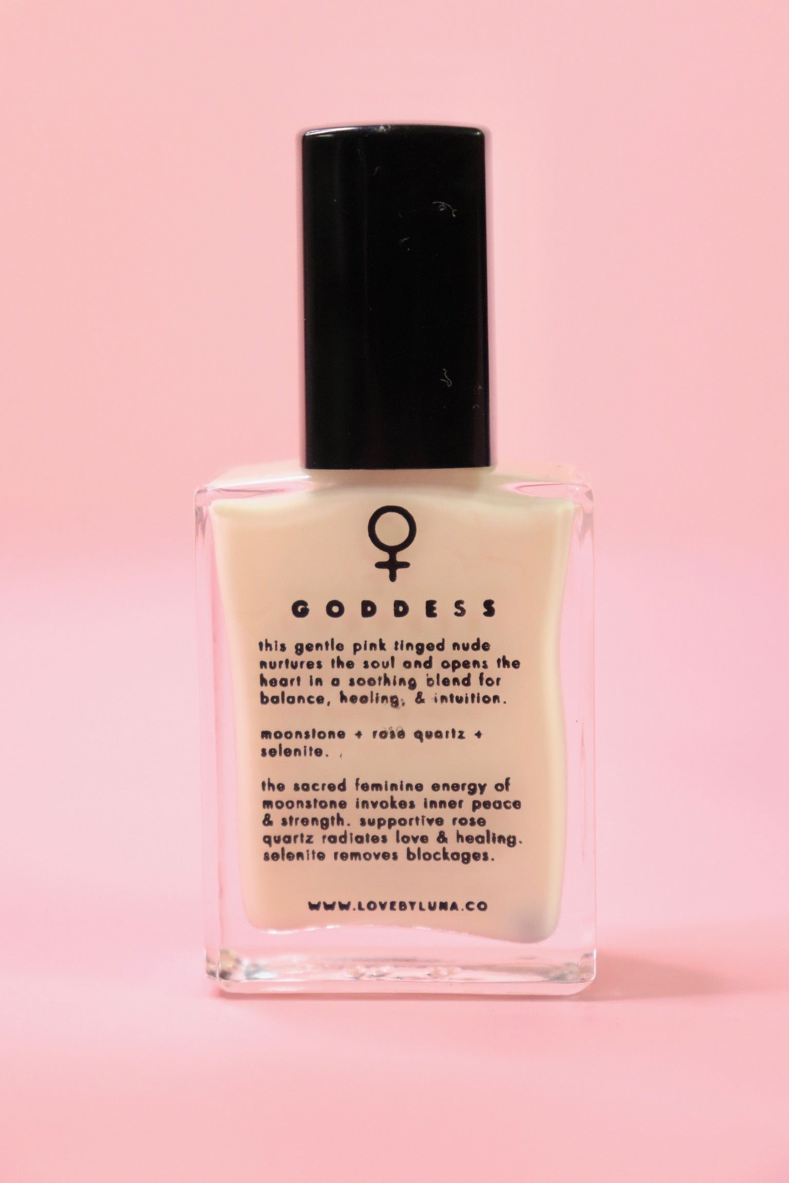 The Goddess Nail Polish with Micronized Rose Quartz, Selenite, & Moonstone on a pink background.