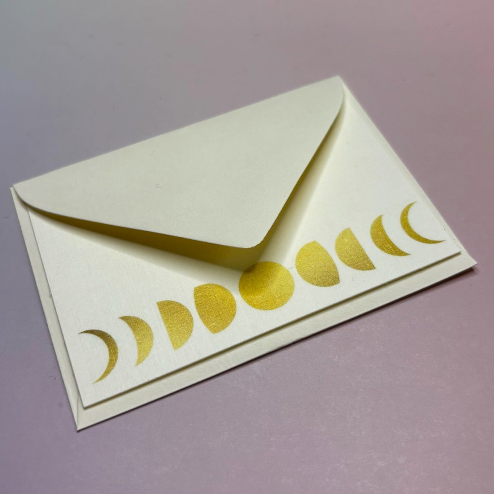 The Moon Phases Mini Card on a purple background.
