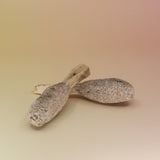 Two of the White Sage and Palo Santo Pops - 3"-4" Smudge Sticks on a pink and yellow background.