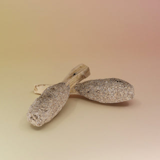 Two of the White Sage and Palo Santo Pops - 3"-4" Smudge Sticks on a pink and yellow background.