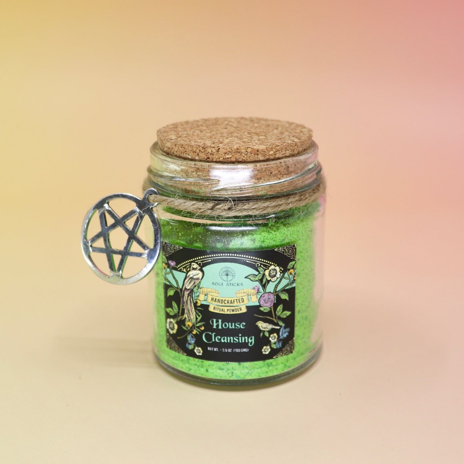 The House Cleansing Ritual Spell Powder Jar - 3.5 oz on a pink and yellow background.