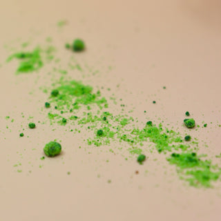 The powder from the House Cleansing Ritual Spell Powder Jar - 3.5 oz on a pink and yellow background.