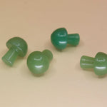 4 Mini Crystal Gemstone Mushrooms on orange background