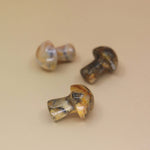 3 Mini Crystal Gemstone Mushrooms on orange background
