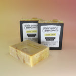 Three of the Buzz Love - Restorative Honey Oat Soaps on a peach-colored background.