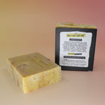 Two of the Buzz Love - Restorative Honey Oat Soaps on a peach-colored background.
