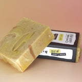 Two of the Buzz Love - Restorative Honey Oat Soaps on a peach-colored background.