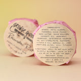 Two of the Rosewater Riot - Conditioner Bars, one showing off the back of the packaging, all on a peach-colored background.