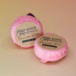 Two Rosewater Riot - Shampoo Bars on a peach-colored background.