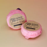 Two Rosewater Riot - Shampoo Bars on a peach-colored background.