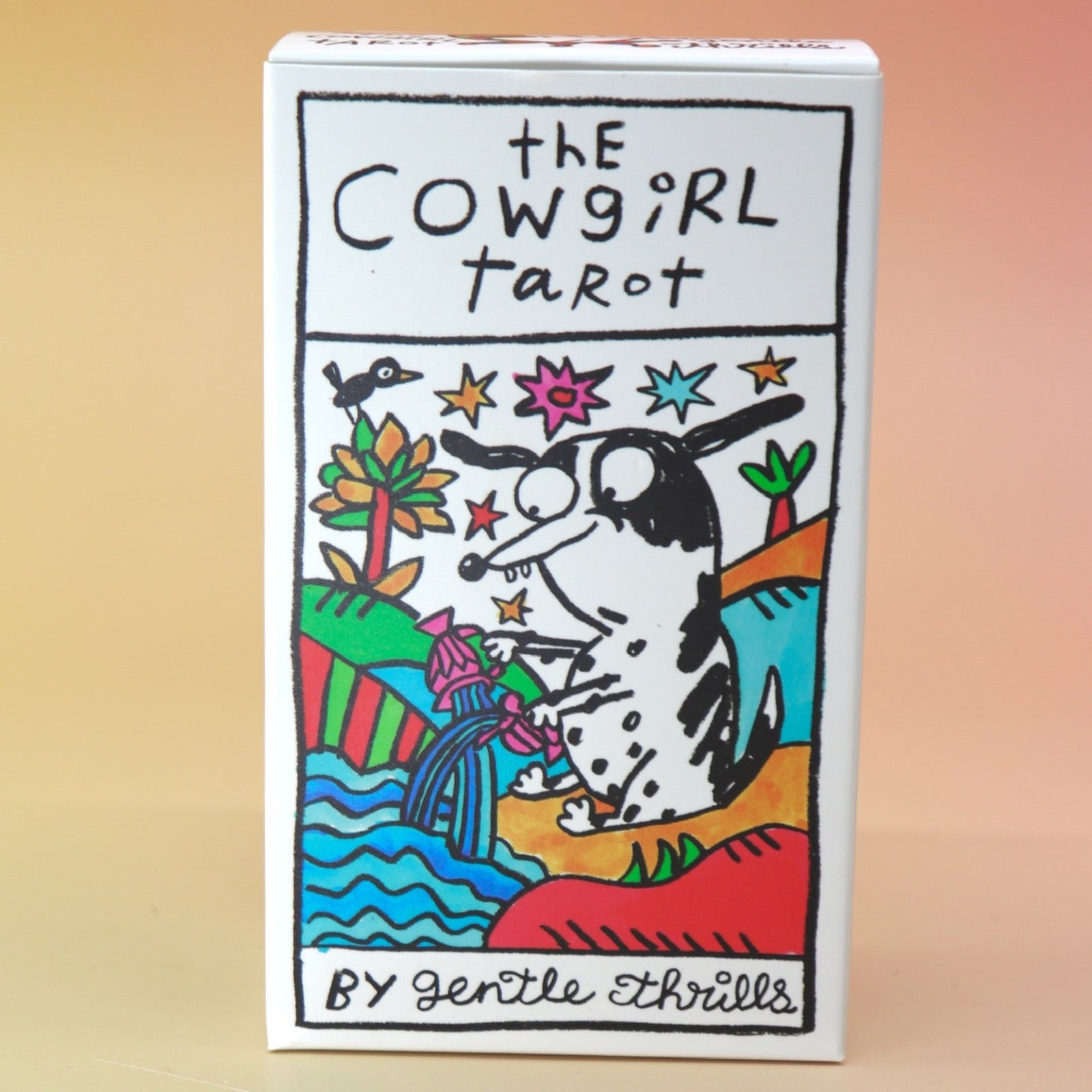 The Cowgirl Tarot Deck on a pink and yellow background.