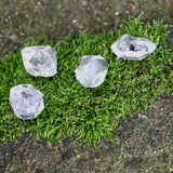 Four Herkimer Diamond Stones on a mossy patch.