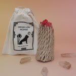 The Nepalese Himalayan Hand Rolled Incense Ropes next to its bag with crystal points surrounding it all on a light pink and yellow background.
