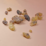 An up close image of the frankincense pieces on a light pink background.