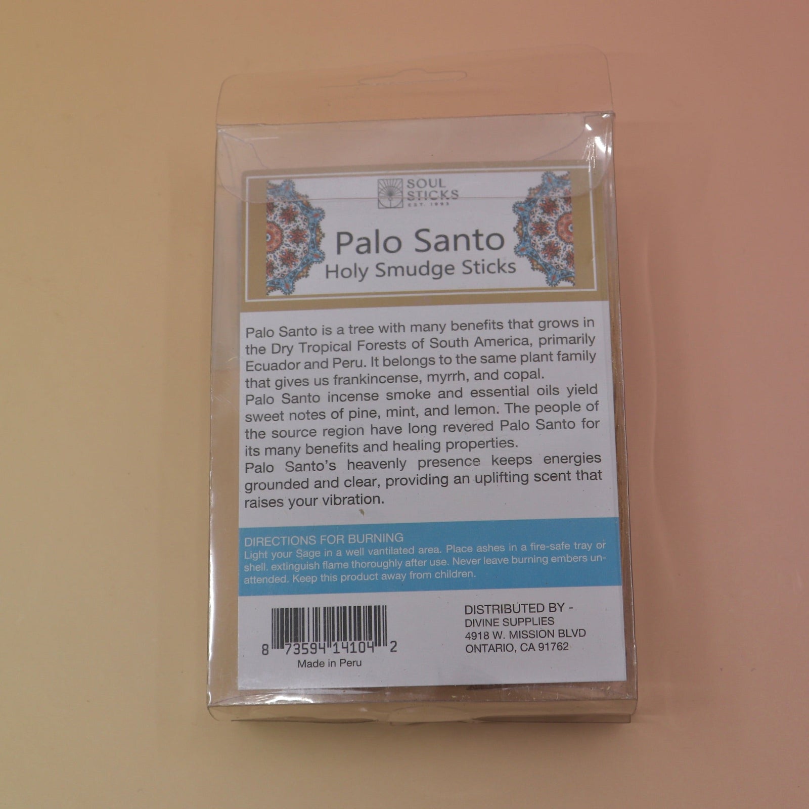 The back of the Holy Smudge Sticks - Pack of 6 4" Palo Santo Sticks on a pink and yellow background.